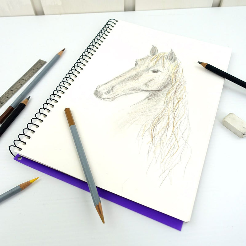 Quill Visual Art Diary A4 open to a pencil drawing of a horse on the white cartridge page, with pencils, a ruler and an eraser on the desk