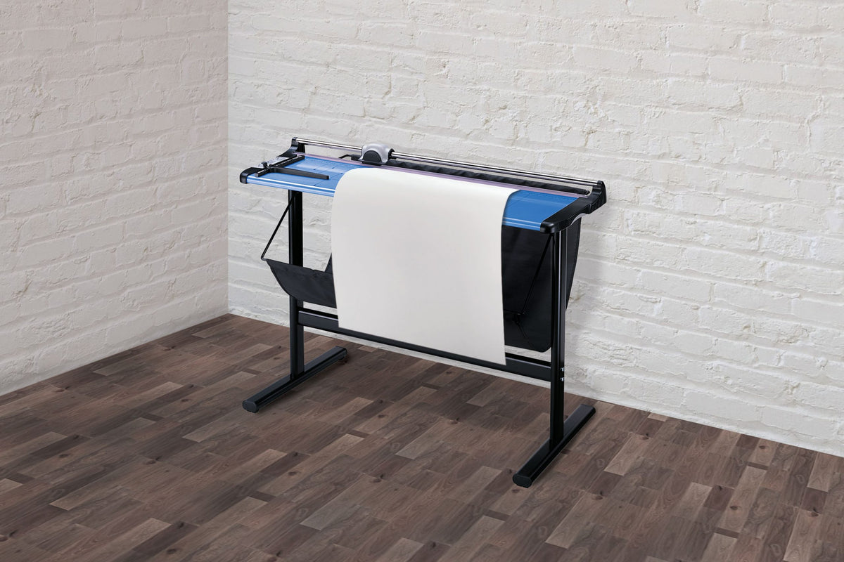 Ledah 960 trimmer on its stand with a large sheet of paper laid across the blue cutting table