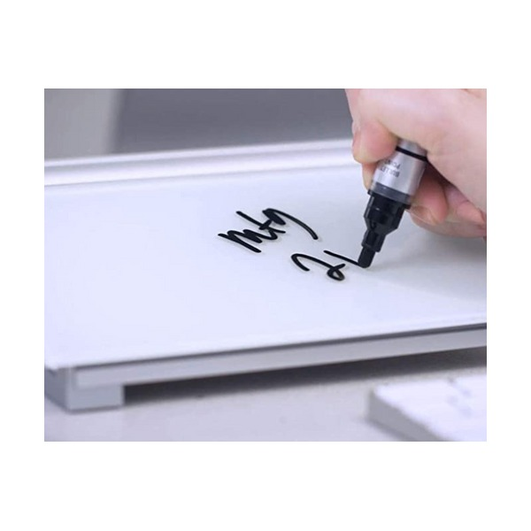 Hand writing on the glass computer pad with a black marker, the silver grey base visible under the glass