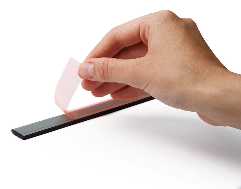 Hand peeling the red backing liner off the self-adhesive back of a Durable Durafix rail