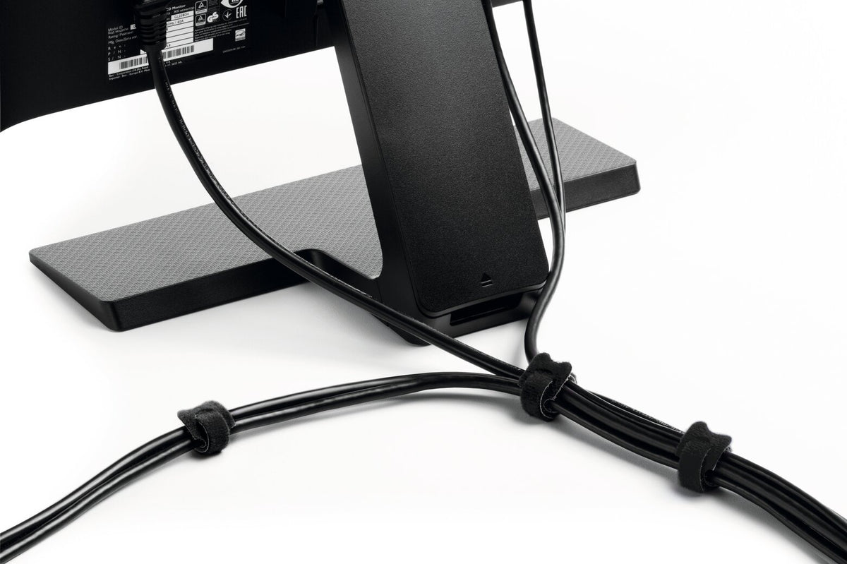 Black CAVOLINE GRIP TIE ties bundling cables behind a monitor stand