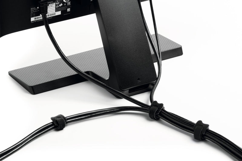 Black CAVOLINE GRIP TIE ties bundling cables behind a monitor stand