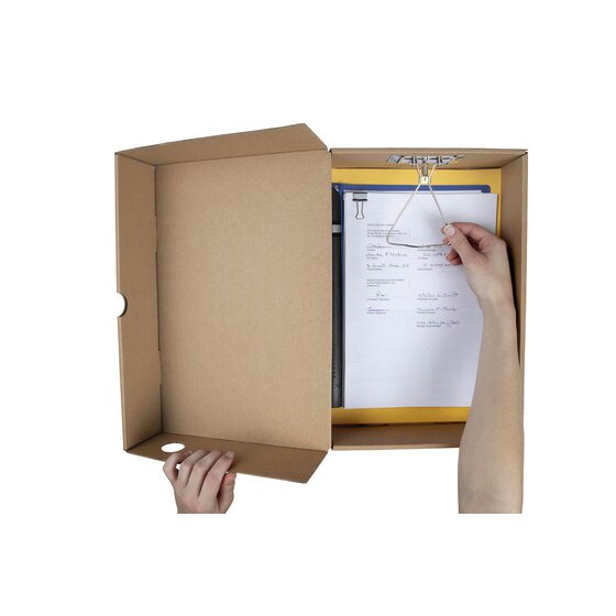 Marbig kraft box file open, hands lifting a metal spring clip that holds a stack of papers on a yellow folder inside the base