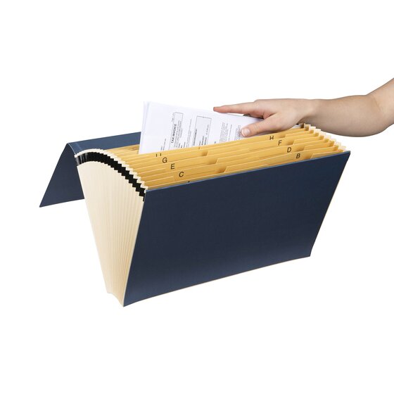 Hand placing a document into the buff A to Z pockets of an open dark grey Marbig expanding file
