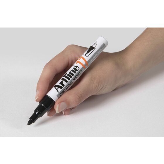 Hand writing with a black Artline 17 Industrial Marker, bullet nib down on a pale grey surface