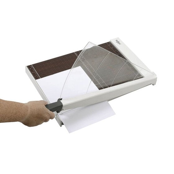 Hand lowering the arm of the Rexel ClassicCut 1710W over a sheet