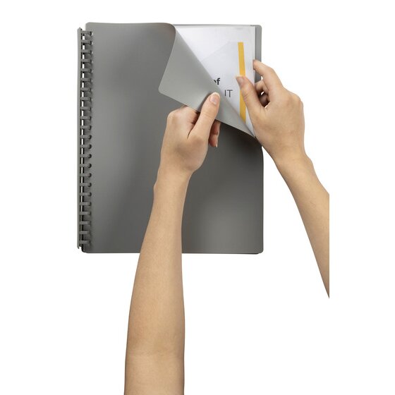 A grey Marbig A4 refillable display book held open in one hand while the other slides a printed page into the first clear pocket behind the grey front cover.