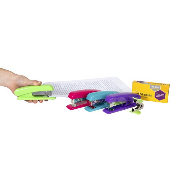 A hand using a lime Marbig half strip stapler on a stack of paper, with pink, blue and purple staplers and a Marbig staples box behind