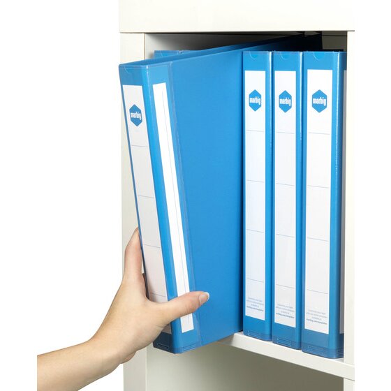 A hand lifting a blue Marbig 5073001 A4 ring binder out of a white cabinet with three more blue binders standing beside it, white spine labels facing out.
