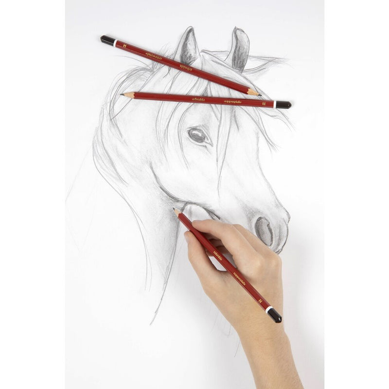 A hand sketching a horse's head in pencil on white paper, with two red Columbia Copperplate pencils with dark brown caps lying across the top of the drawing