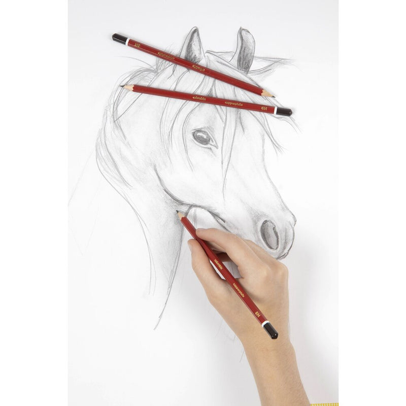 A hand sketching a horse's head in pencil on white paper, with two red Columbia Copperplate pencils with dark brown caps lying across the horse's ears and mane