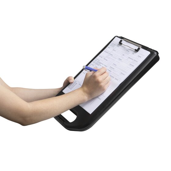 Hand writing with a blue pen on a form held by the wire clip of the black Marbig storage clipboard 0280510