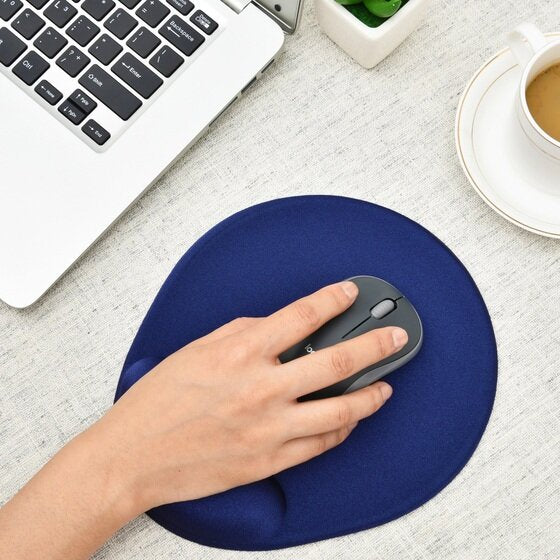 Hand using a grey mouse on the blue Dac MP127 mouse pad beside a laptop keyboard and a cup of coffee on a light desk