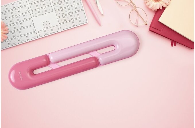 Pink desk wrist rest on a pink desk with office supplies