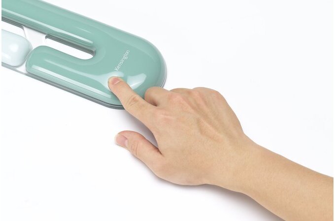 Hand pressing a teal-colored electronic device on a white background