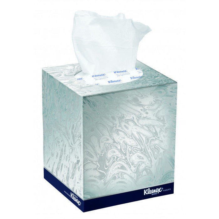 Kleenex facial tissue cube in a white and silver pattern with a navy base band and a white tissue rising from the top opening