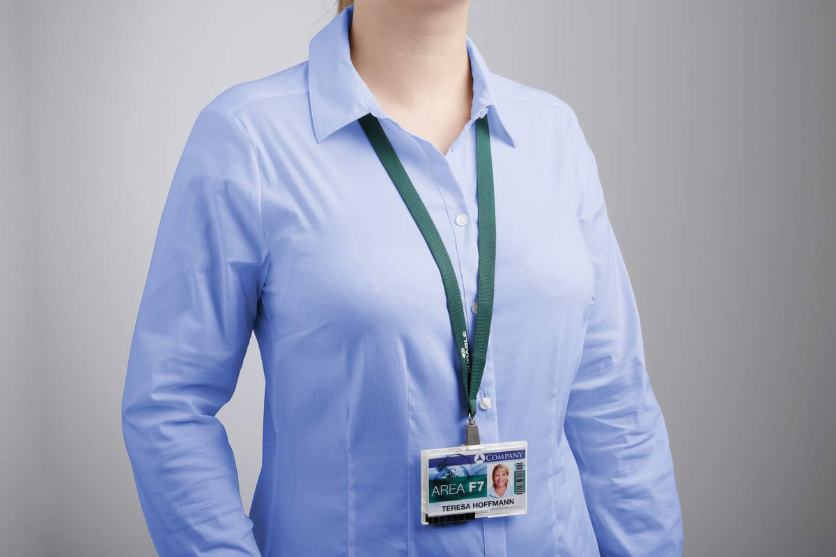 Woman in a blue shirt wearing a dark green Durable lanyard with a card holder