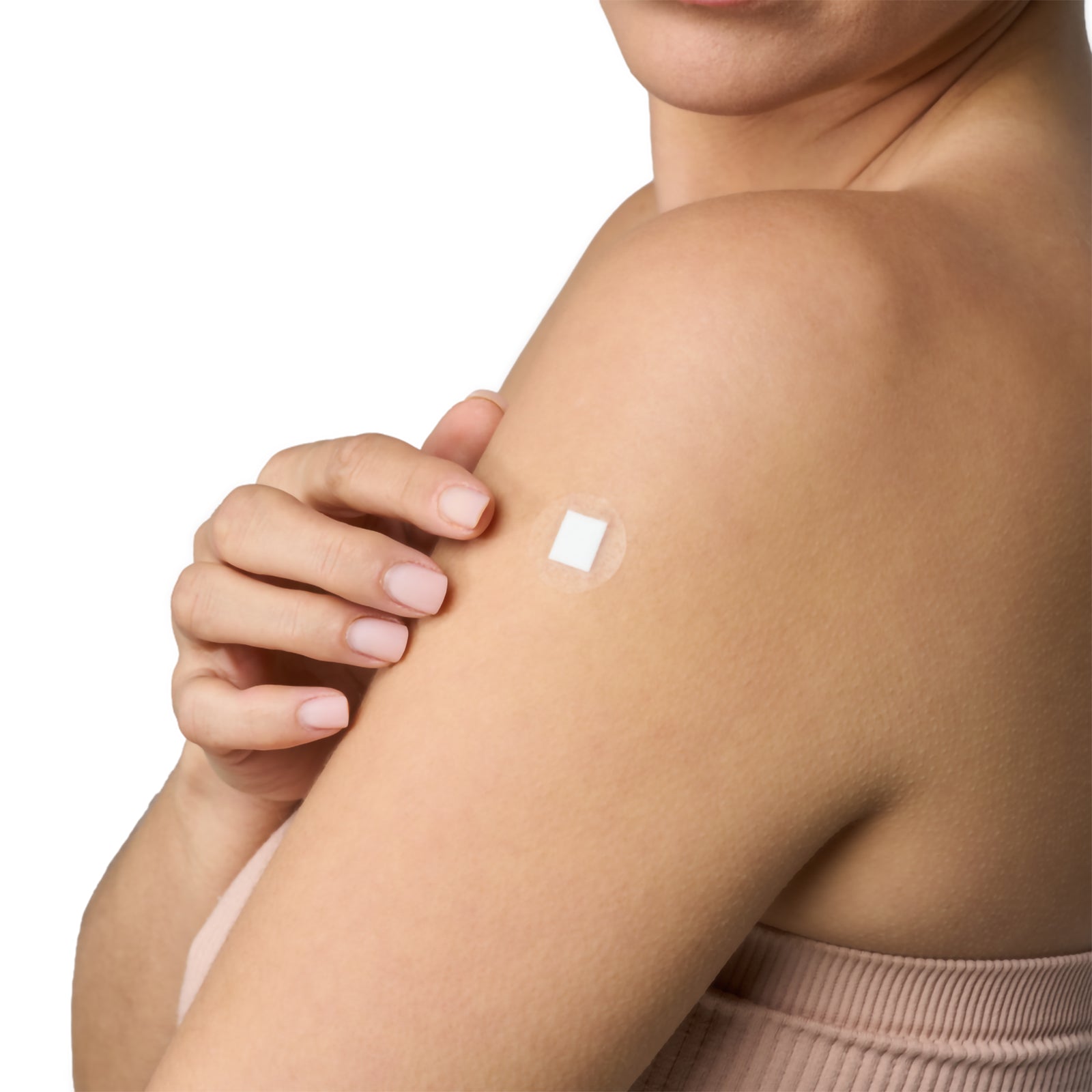 AeroPlast AquaGuard transparent spot dressing positioned on an upper arm, demonstrating how the clear circular film blends with surrounding skin while the white central wound pad provides focused coverage over a small wound site.