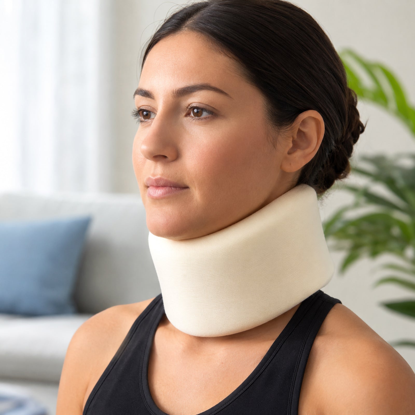 Front angled lifestyle view of the AeroSupplies Foam Cervical Collar Small being worn, clearly showing the contoured foam construction around the jaw and neck with a natural upright head position.