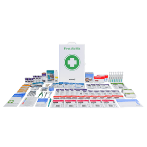 The white metal cabinet standing behind the food and beverage kit contents laid out in rows across several columns