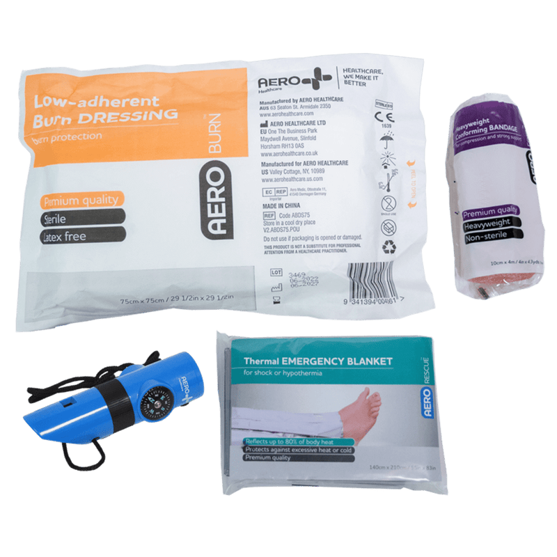 The remote work module contents laid out, including a burn dressing, a conforming bandage, a torch and a thermal emergency blanket
