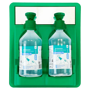 Green moulded wall station holding two clear eyewash bottles with green caps and instruction labels
