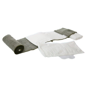Rolled trauma bandage shown beside its dressing pads and sealed wrappers on a plain background
