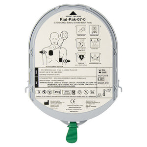 Grey oval Pad-Pak cartridge printed with its instruction pictograms and the part number, the combined electrode pad and battery pack for the defibrillator