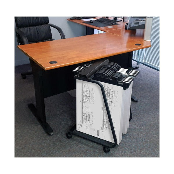 Small black Hang-A-Plan trolley holding drawings on clamps, parked beside an office desk with a chair