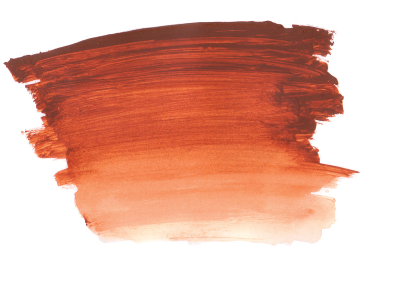 Brush-out swatch of Chroma Atelier Interactive Trans Red Oxide acrylic paint showing a deep brick red that fades through terracotta to salmon