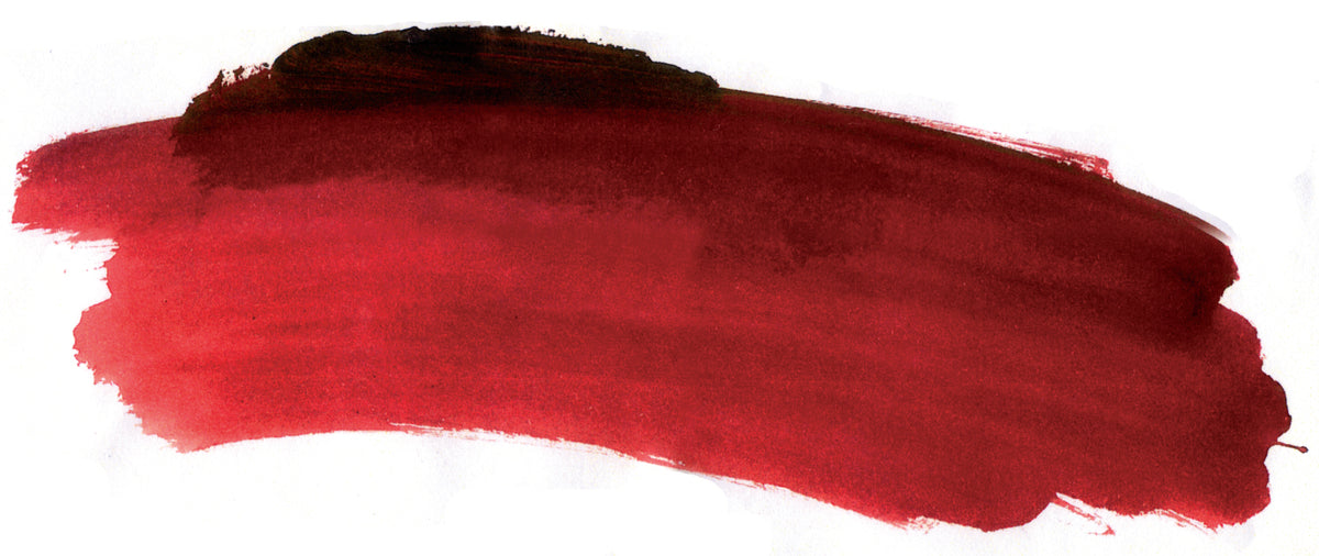 Brush-out swatch of Chroma Atelier Interactive Perm Brown Madder acrylic paint showing a deep wine red with darker edges