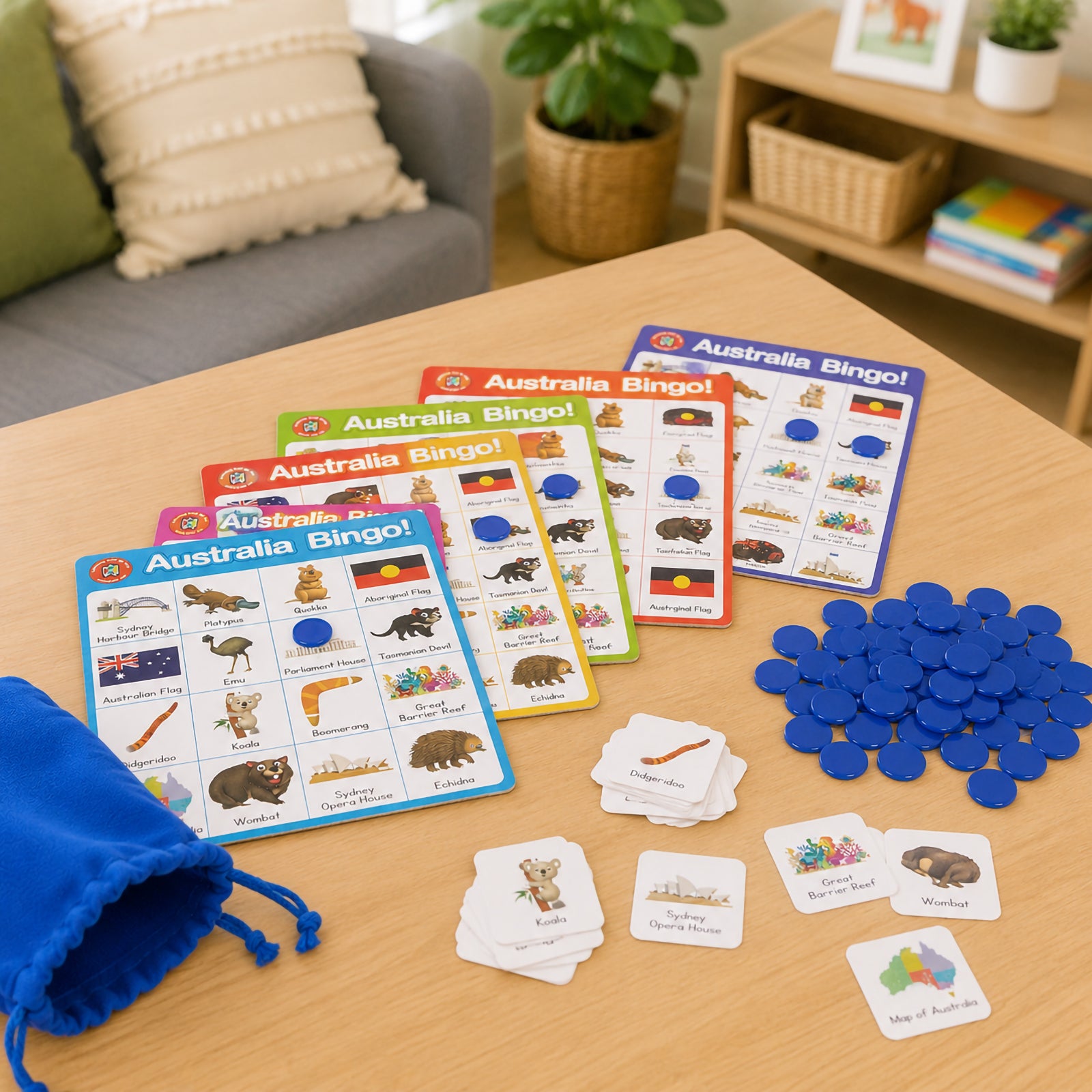 Australia Bingo game setup displaying multiple colourful bingo boards, Australian themed picture tokens and blue counters on a tabletop. Featured illustrations include native animals, famous landmarks and cultural symbols that support Australian studies and educational learning activities.