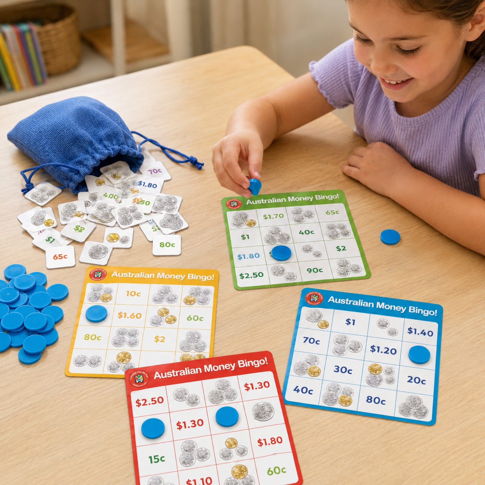Young learner enjoying Learning Can Be Fun Australian Money Bingo at a classroom table. The image shows colourful bingo boards, Australian money tokens, blue counters and a drawstring storage bag. Children actively match coin values and money amounts while developing counting skills, coin recognition and financial literacy through engaging educational play.