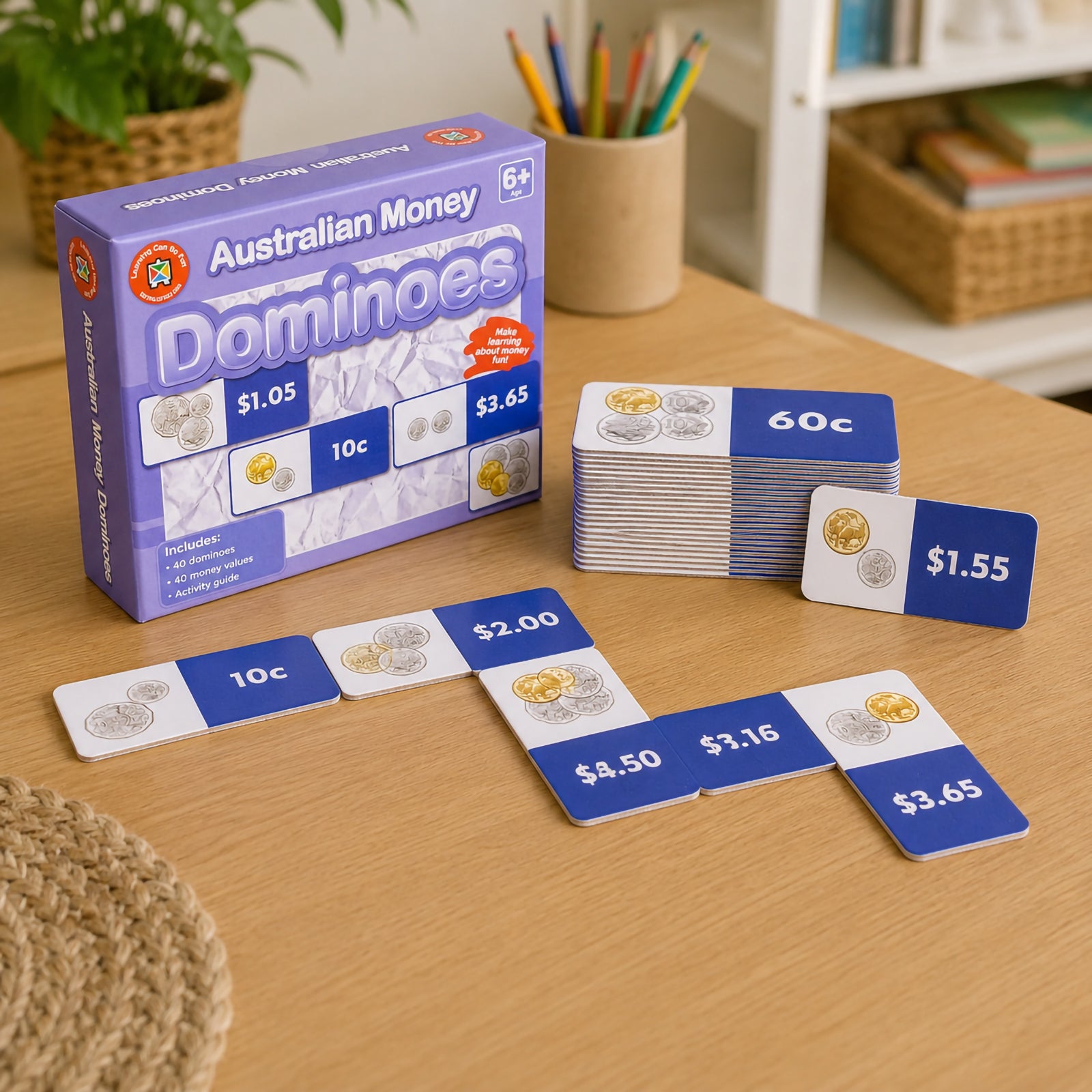 Australian Money Dominoes set displayed on a classroom table with domino cards, retail packaging and money value examples. The image highlights the educational resource designed to teach financial literacy and practical money skills.