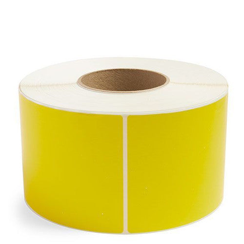 Close-up of yellow 100x100mm direct thermal label showing permanent adhesive backing