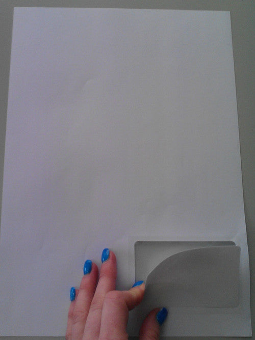 Close-up of peel-off business card in left corner of A4 sheet