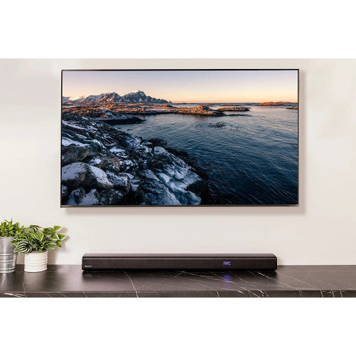 BlueAnt XT120 wall-mounted above a television in a home theatre setup