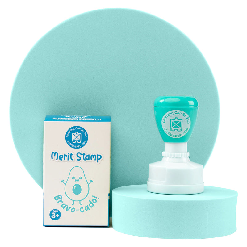Retail packaging and Bravo-cado merit stamp presented on a coordinated display stand. The packaging highlights the playful avocado artwork and self inking design, making it a practical and enjoyable teacher resource.