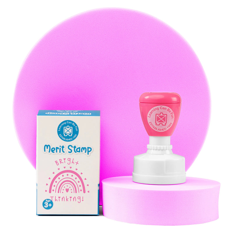 Retail packaging and Bright Thinking self inking stamp displayed together on a presentation stand. The packaging highlights the cheerful rainbow design and educational reward theme suitable for schools and learning environments.