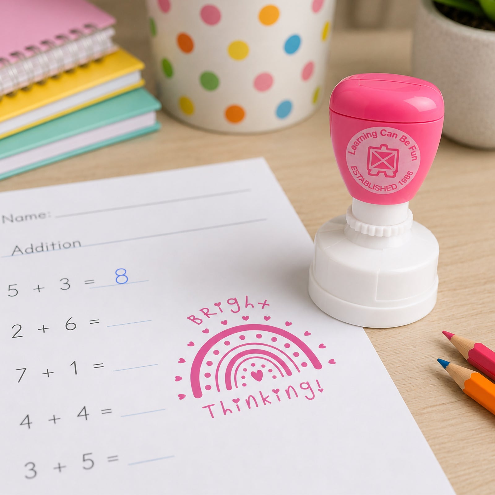 Self inking reward stamp shown beside a completed maths worksheet with a clear Bright Thinking impression. The image demonstrates how teachers can provide immediate recognition for thoughtful work and problem solving skills.