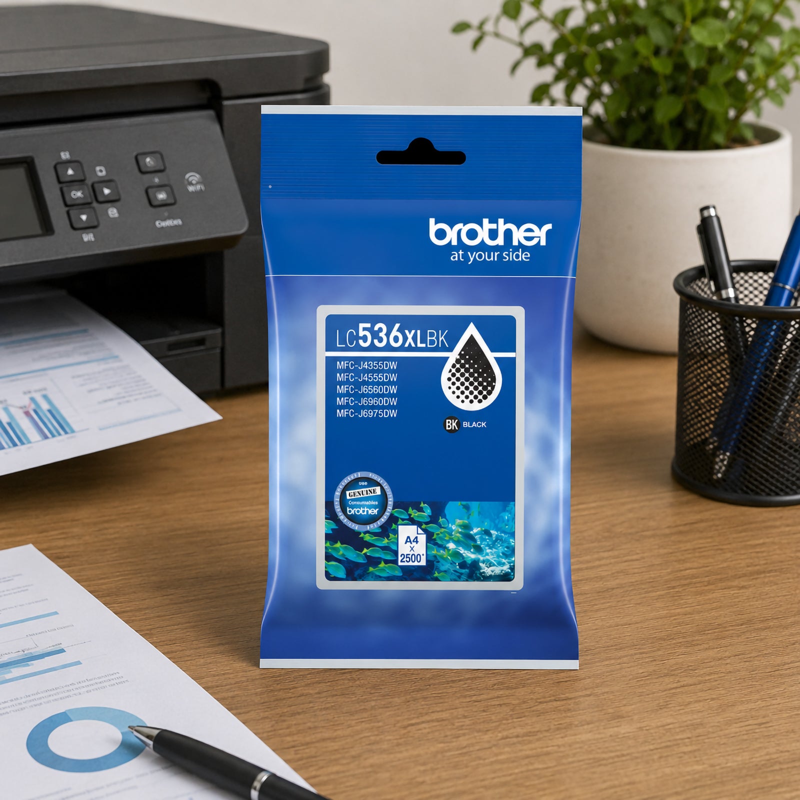 Brother LC536XLBK High Yield Black Ink Cartridge displayed on a clean office desk beside a Brother multifunction printer. The packaging stands upright near a notebook, printed business documents and an indoor plant, creating a productive workspace environment. The image highlights the cartridge as a dependable choice for everyday office printing, professional documents and high volume business tasks.