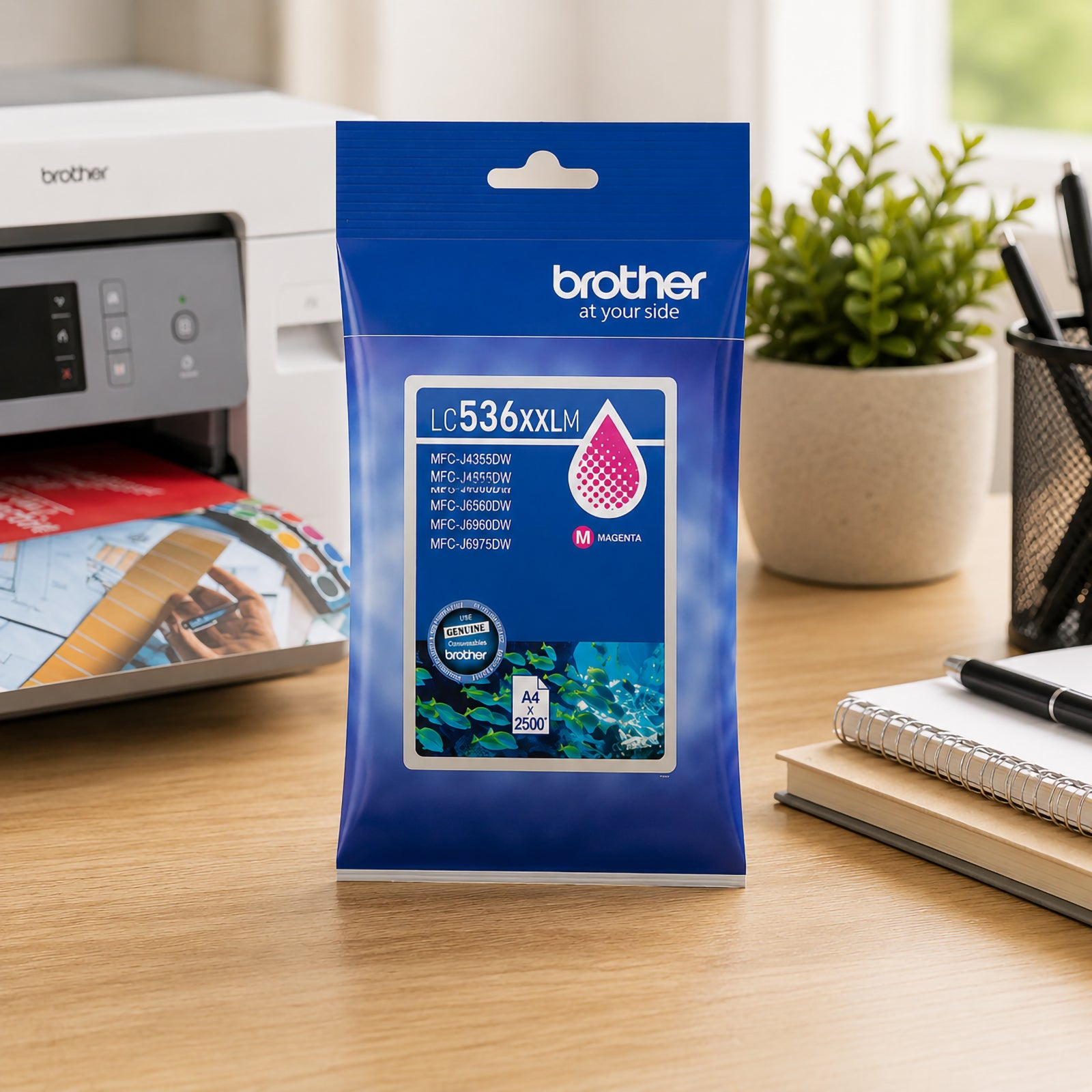 Front facing display of the Brother LC536XXLM magenta ink cartridge package positioned on a desktop near a Brother printer, notebook and office stationery. The image emphasises genuine Brother consumables designed for reliable, high quality colour document production.