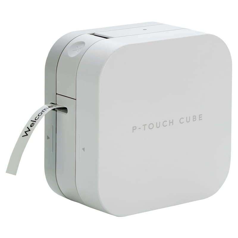 Close view of the white Brother PT-P300BT P-Touch Cube with a printed label reading Welcome feeding out of the tape exit slot on the left side, and the manual cutter button visible on the top panel, on a white background