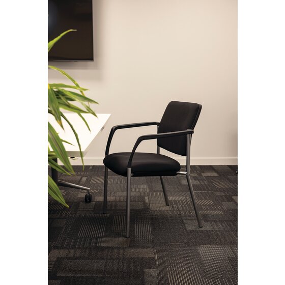 Alternate angle of the Buro Lindis visitor chair highlighting the PU moulded foam seat and high density foam back in black fabric with silver powder coated legs