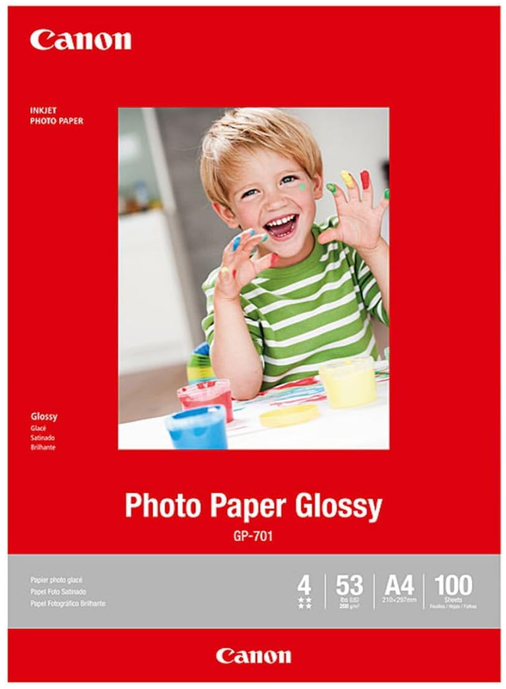 Canon Photo Paper Glossy GP-701 photo paper pack, featuring a bright red cover with a sample photo of a smiling child in a green striped shirt, and product specifications at the bottom.