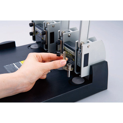Carl 123N punch with self-centring paper guide in use on a stack of documents