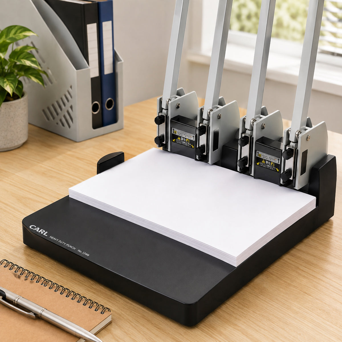 Store image: desk scene with a stack of paper loaded under the heads of a Carl No.124N punch