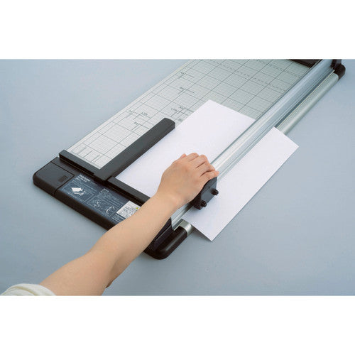 Carl DC250 trimmer showing magnetic paper guide and size markings on cutting mat