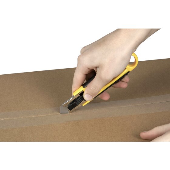Hand holding a yellow Celco auto retractable cutter and slicing through the packing tape on a cardboard carton