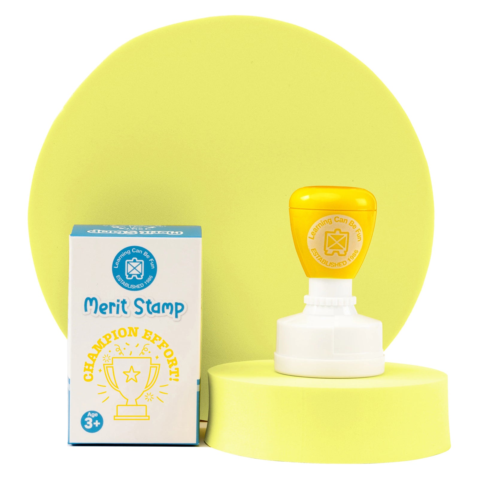 Retail packaging and Champion Effort self inking merit stamp presented together on a display platform. The trophy themed reward stamp is designed to celebrate hard work, perseverance and student success.